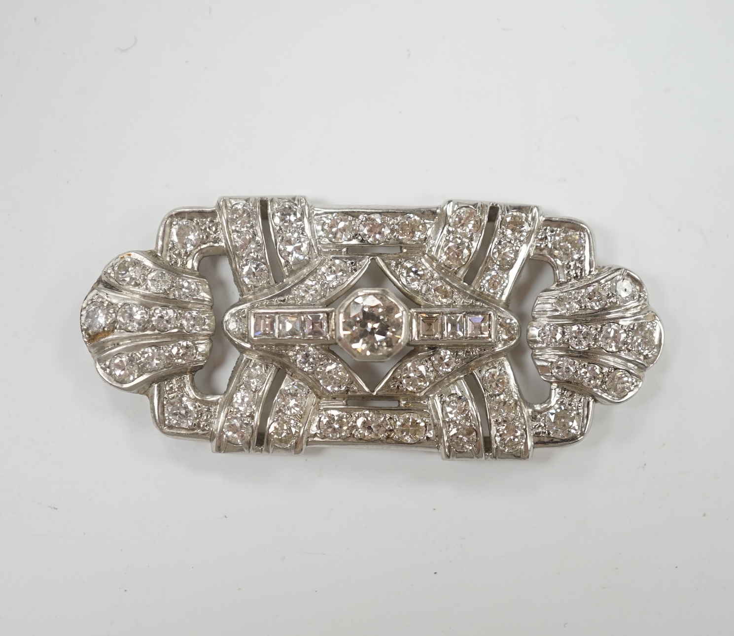 A white metal and diamond cluster set shaped rectangular brooch? (lacking fittings)